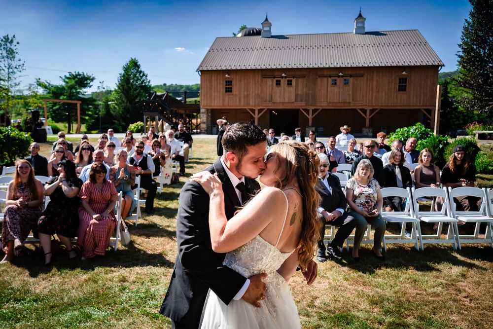 Motion blur photo of wedding guests dancing and celebrating at outdoor reception.