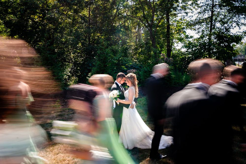 Motion blur captures dancing and movement at outdoor wedding reception.