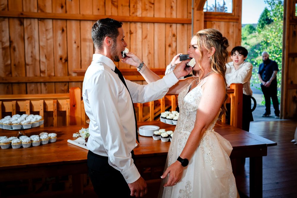 Rustic barn wedding reception with wooden walls and twinkling lights creating a warm atmosphere.