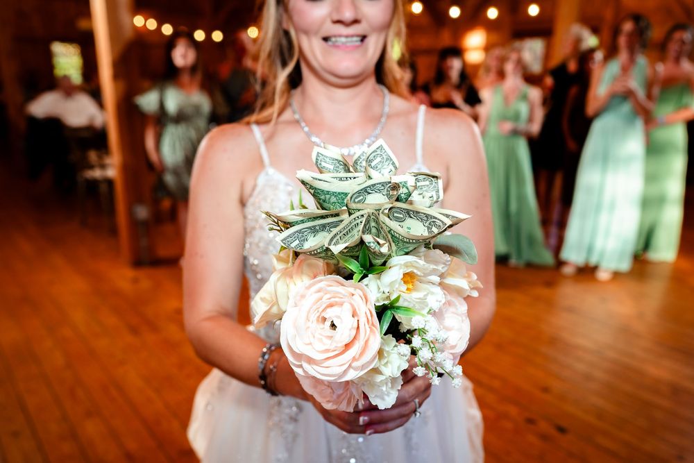 Wedding reception details showing floral arrangements and decorative elements in a rustic barn setting.