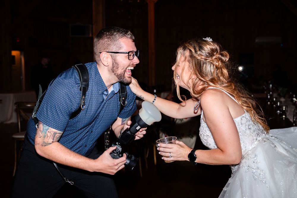 Wedding reception candid moments captured in dark lighting with intimate atmosphere.