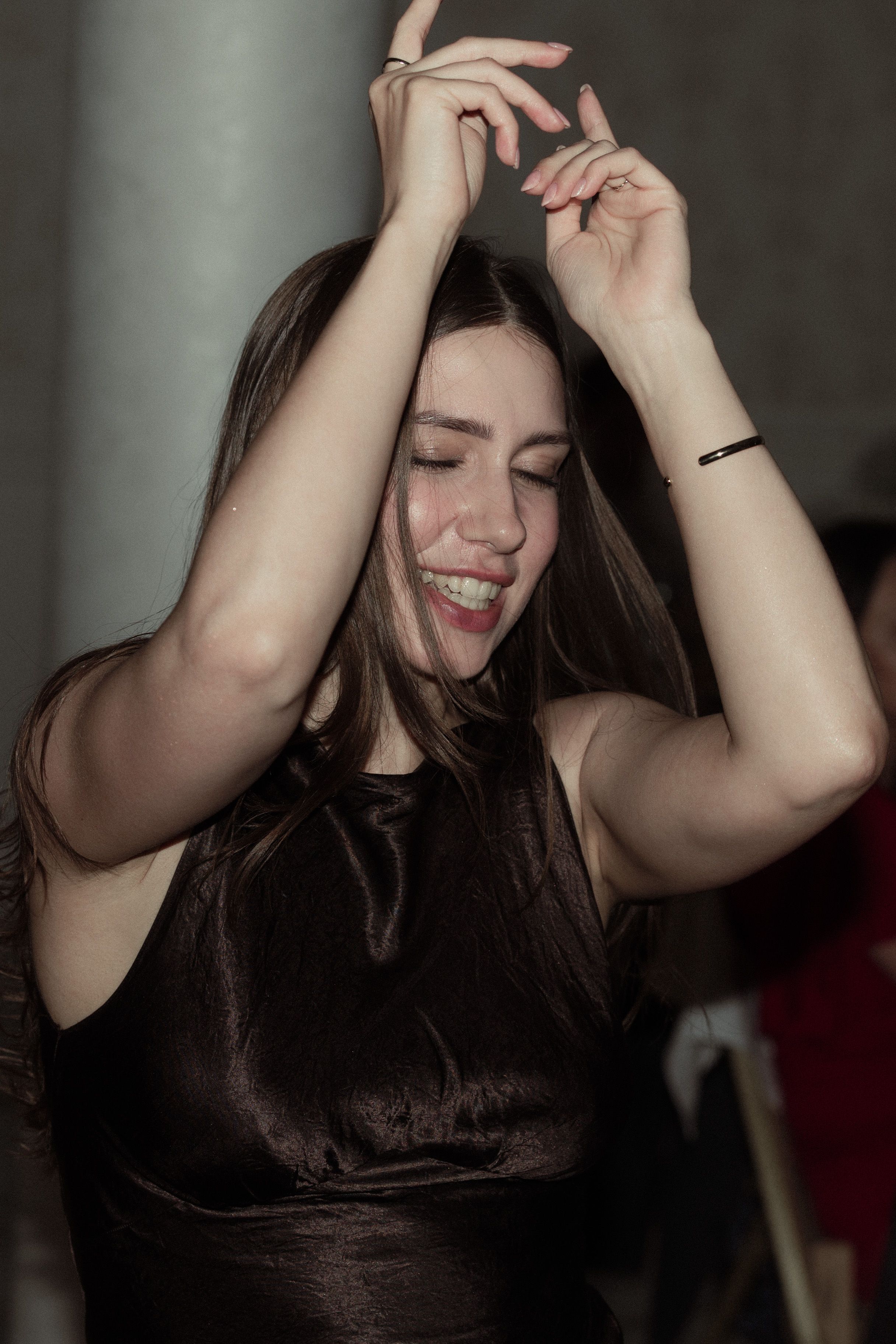 A sequence of photos shows joyful motion as dark hair swings through candid laughing moments.