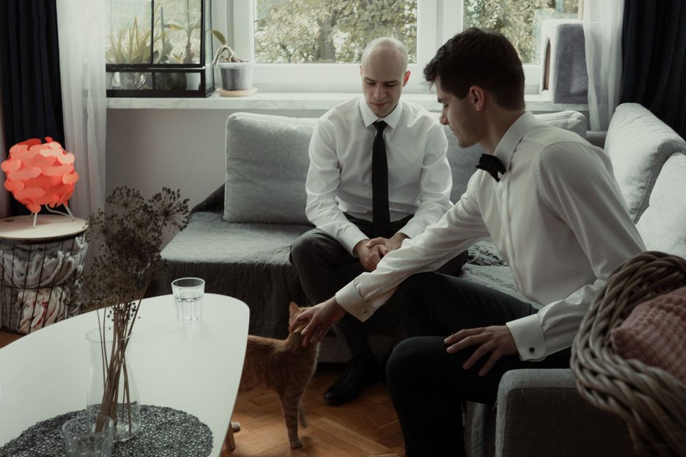 A group of people sits at a dining table discussing and collaborating together in a modern office setting.