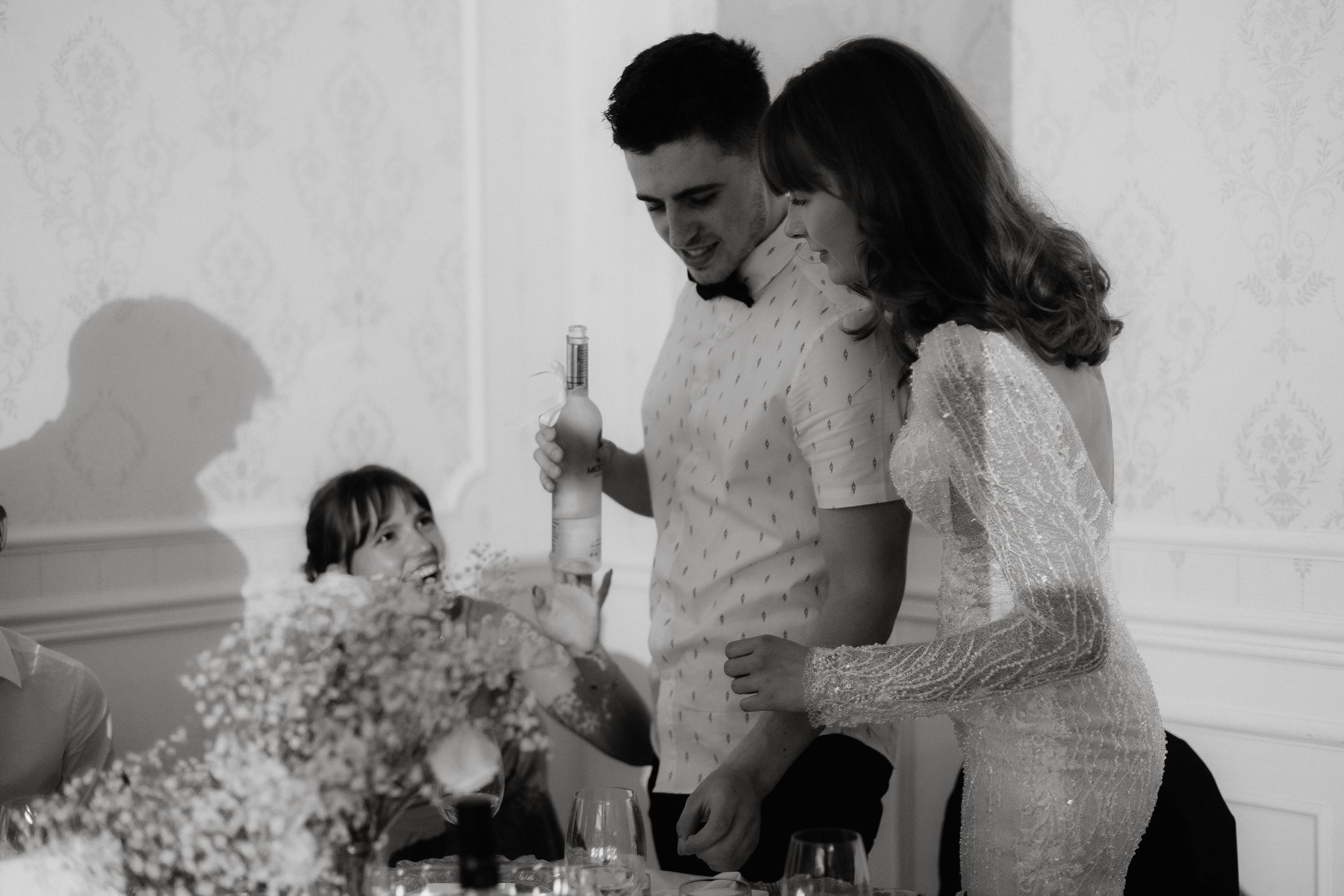 A vintage black and white photo shows five wedding reception moments arranged in a sequence.