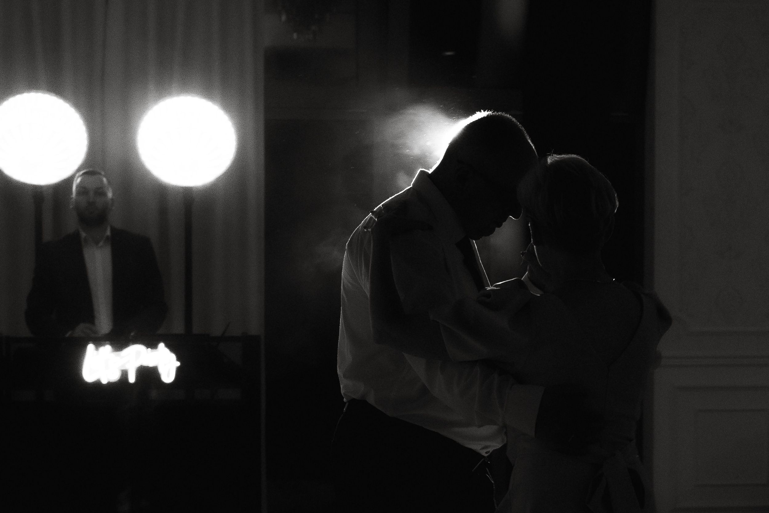 A collection of black and white film noir style shots showing dramatic lighting and silhouettes in a dark hallway.