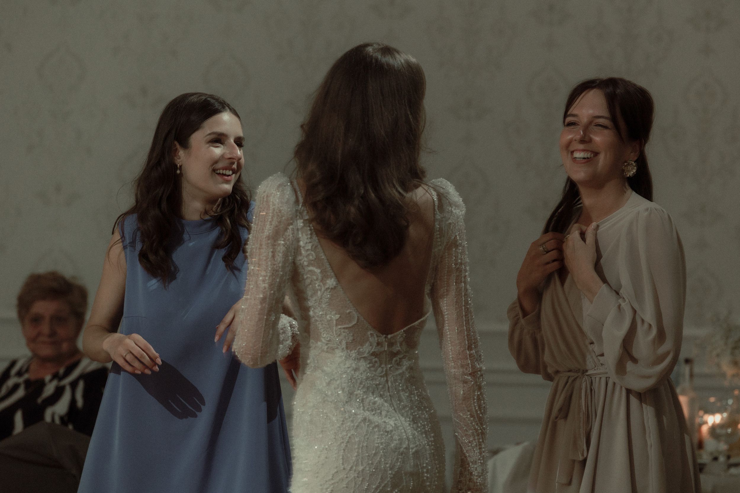 A group celebrating and embracing at an elegant indoor celebration.