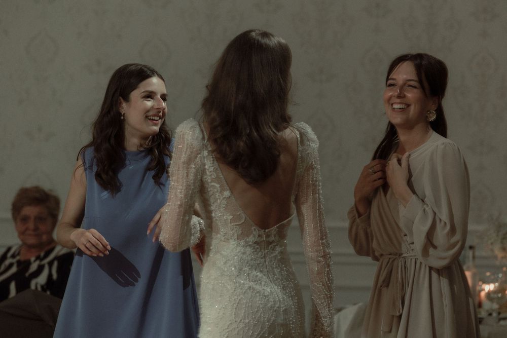 A group celebrating and embracing at an elegant indoor celebration.