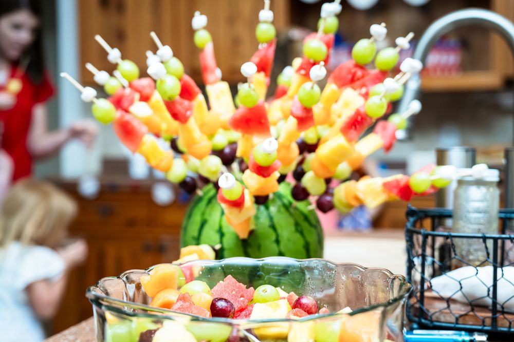 Colorful fruit and snack kabobs displayed at a party.