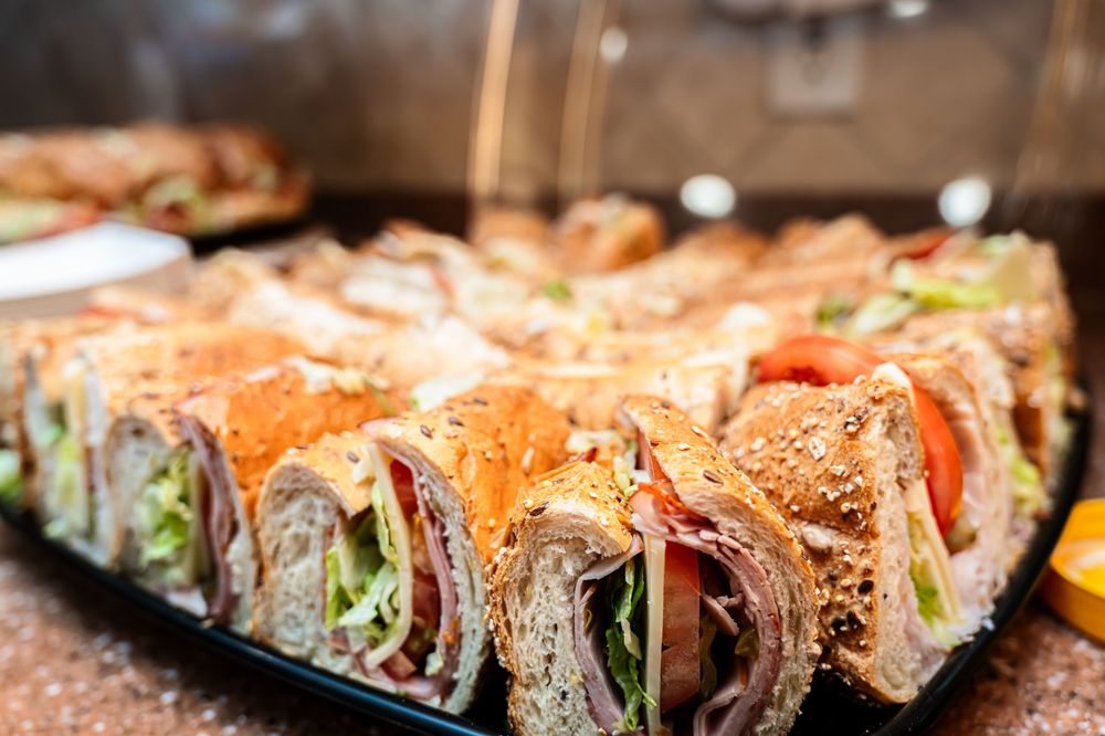 Close-up view of colorful sushi rolls arranged on a dark plate.