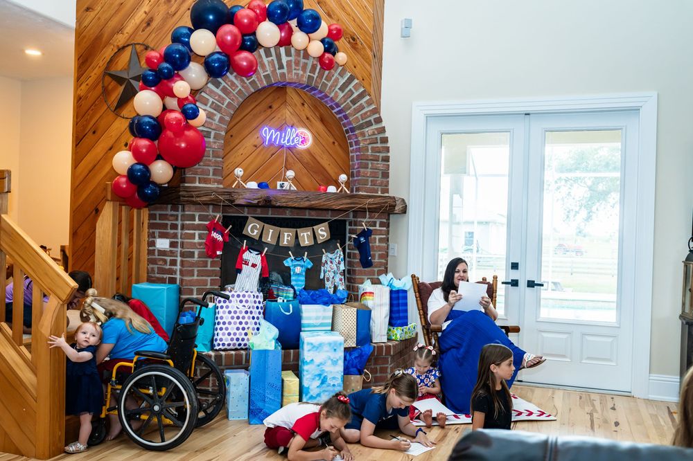 Party space decorated with red and blue balloon arch and festive decorations.