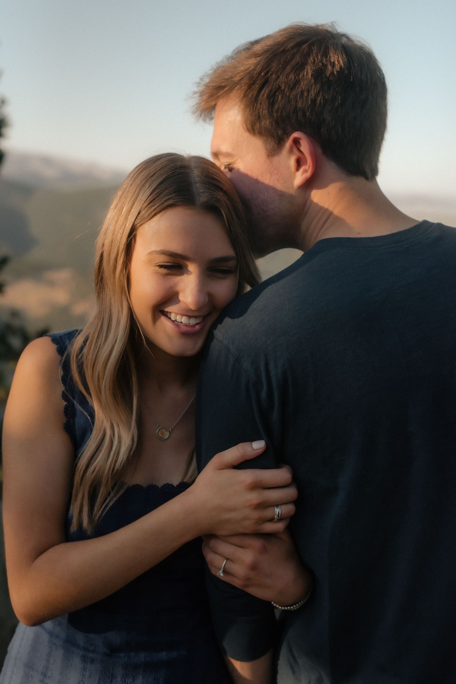 A romantic series of photos showing a couple embracing against a scenic mountain backdrop at sunset.