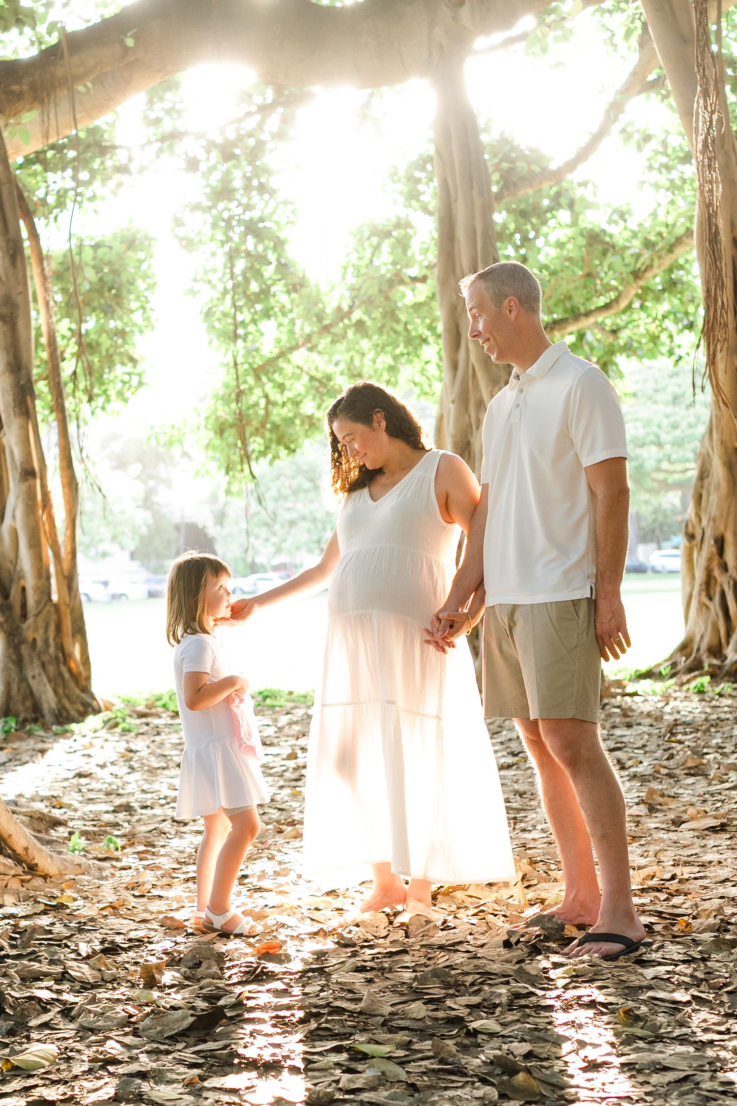 A loving maternity photoshoot series shows a tender family moment in a sun-drenched outdoor setting.
Oahu family photography, Hawaii family