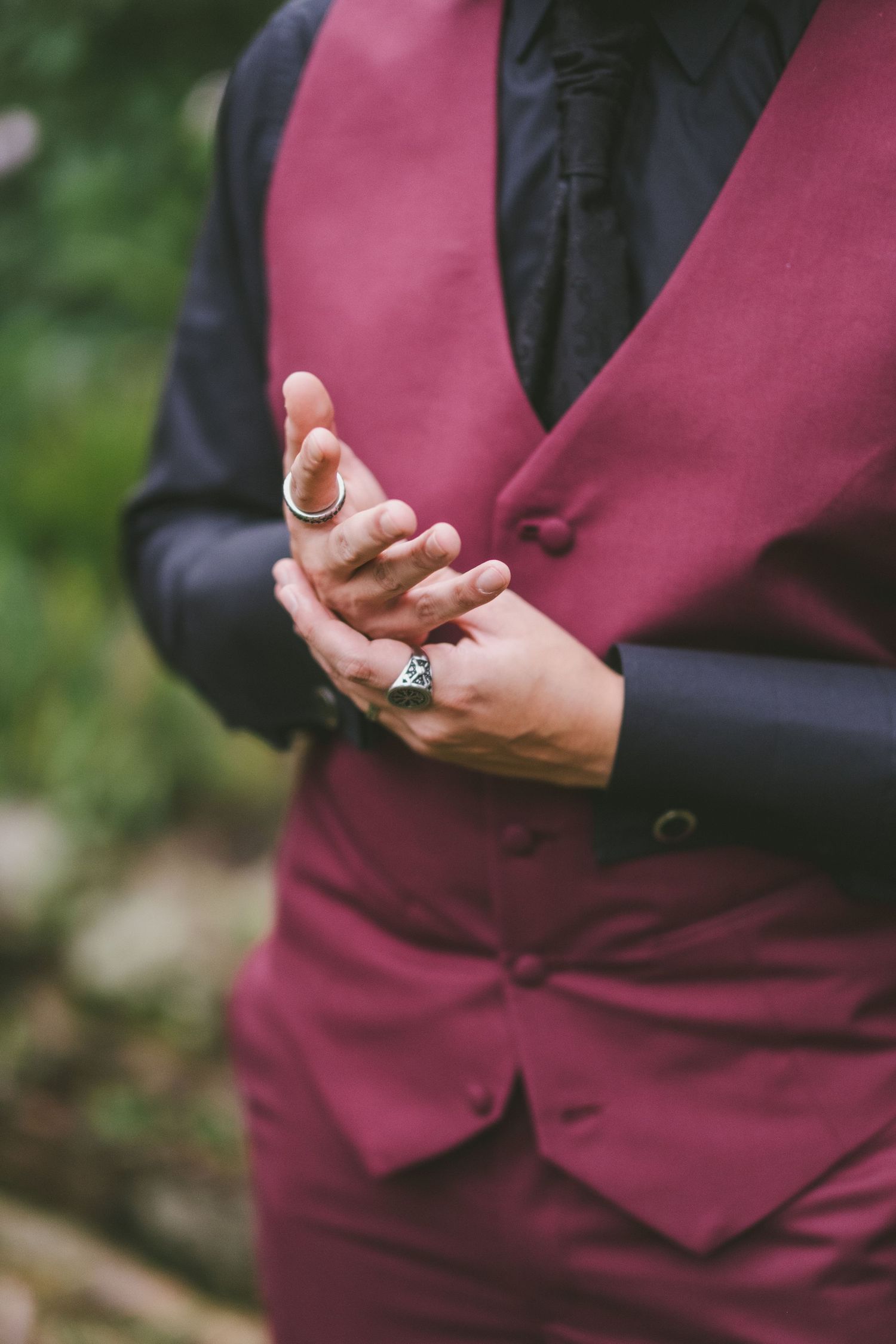 Close up views of green and silver bolo ties worn with white dress shirts and floral boutonnieres in a formal setting.