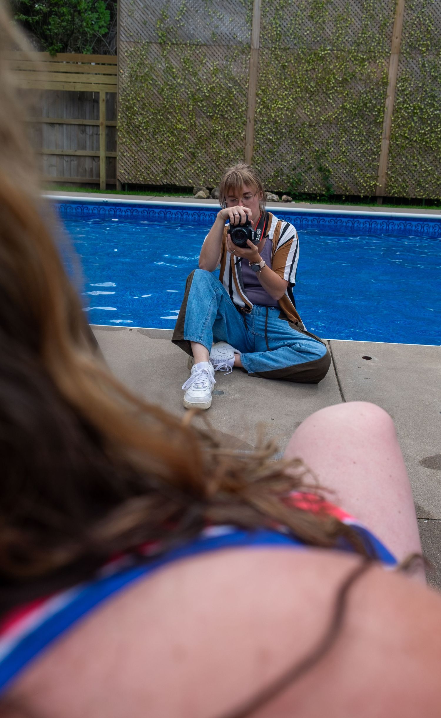 A series of sequential photographs showing someone using a camera by a swimming pool with blue water.