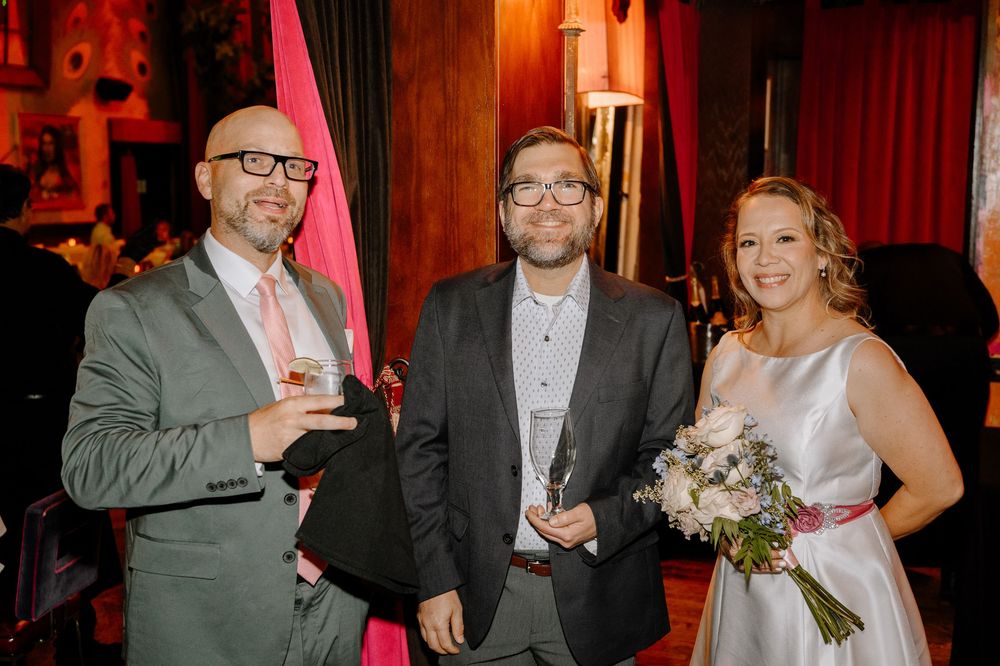 Wedding celebration scenes showing couples and guests socializing and dancing in a warmly lit venue with red decor.