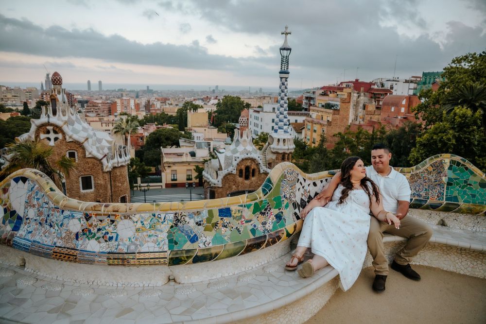 Natalia & Hector sharing a joyful moment in front of Gaudí’s colorful mosaics.