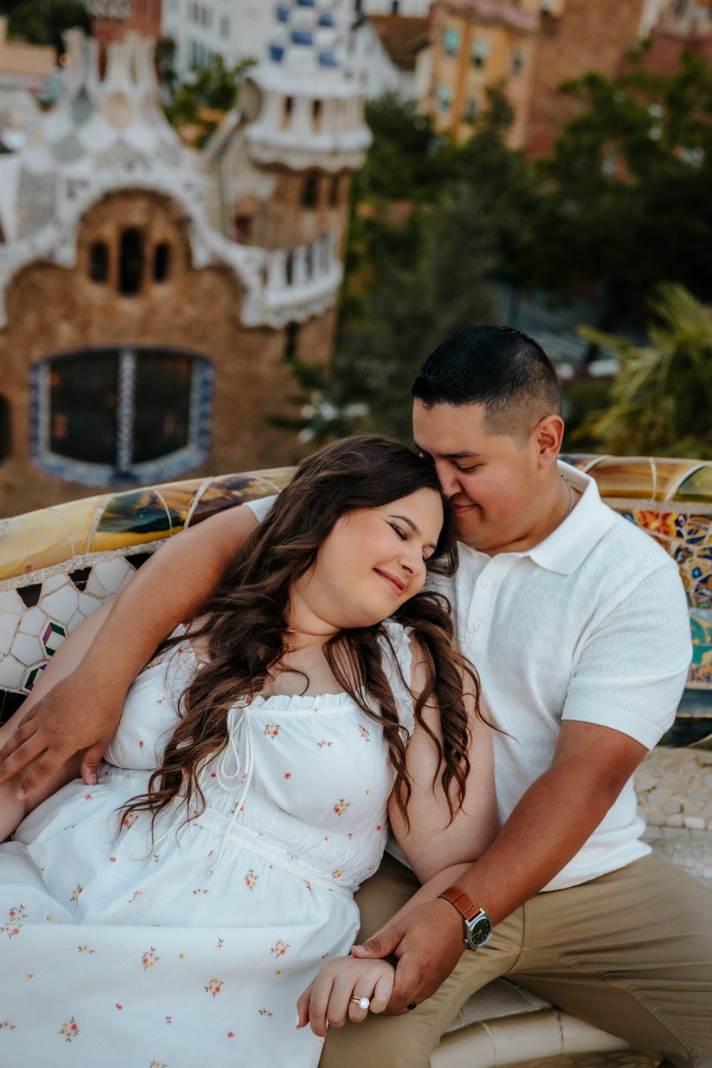 Tender embrace of Natalia & Hector captured against vibrant Park Güell tiles.