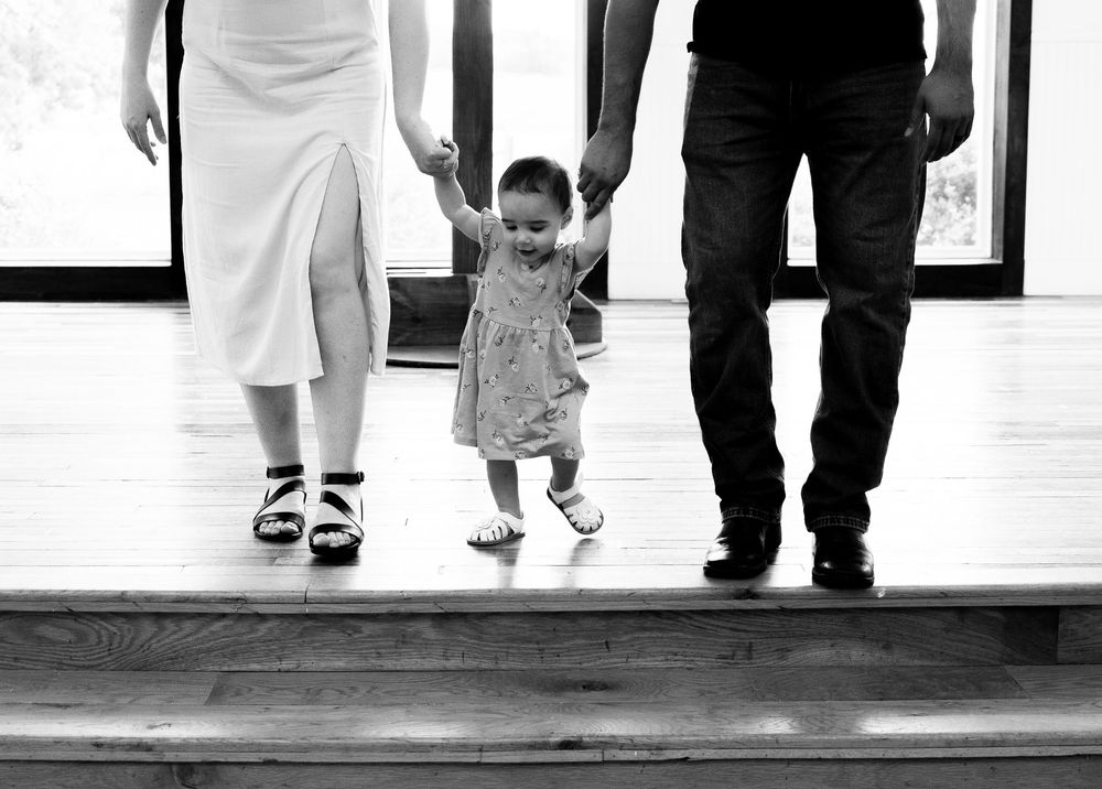 Black and white images showing multiple people's lower bodies walking together, featuring formal attire and elegant shoes.