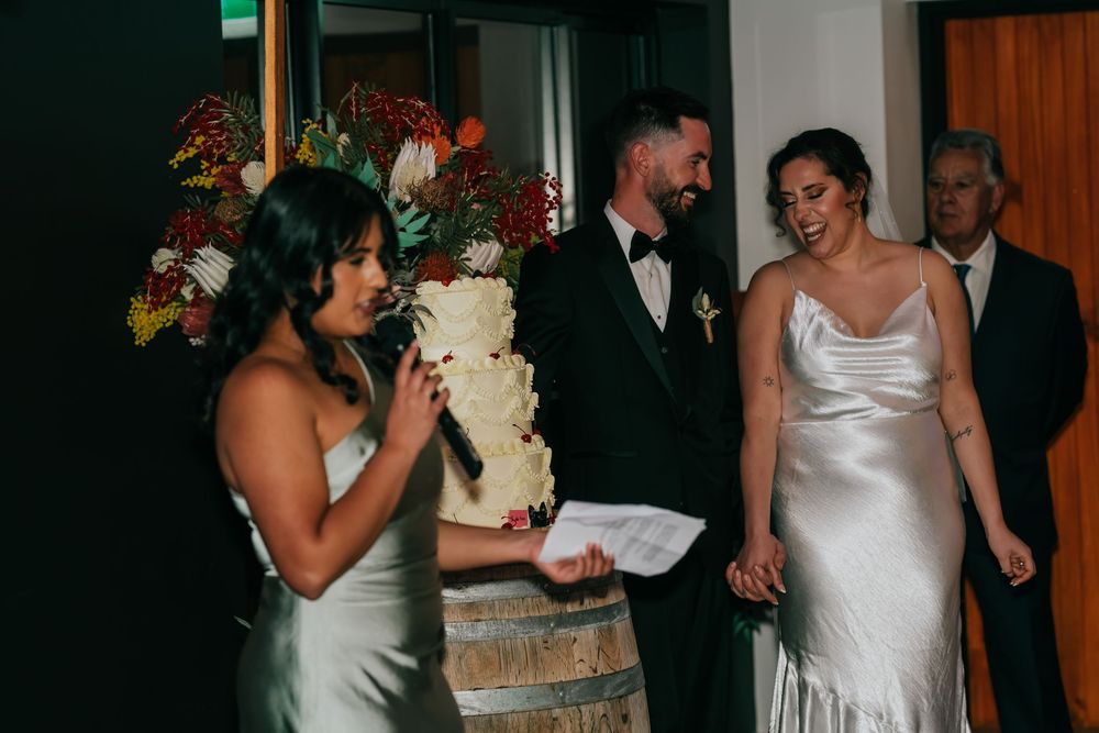 People dining and celebrating at what appears to be a wedding reception with decorative white tablescapes.