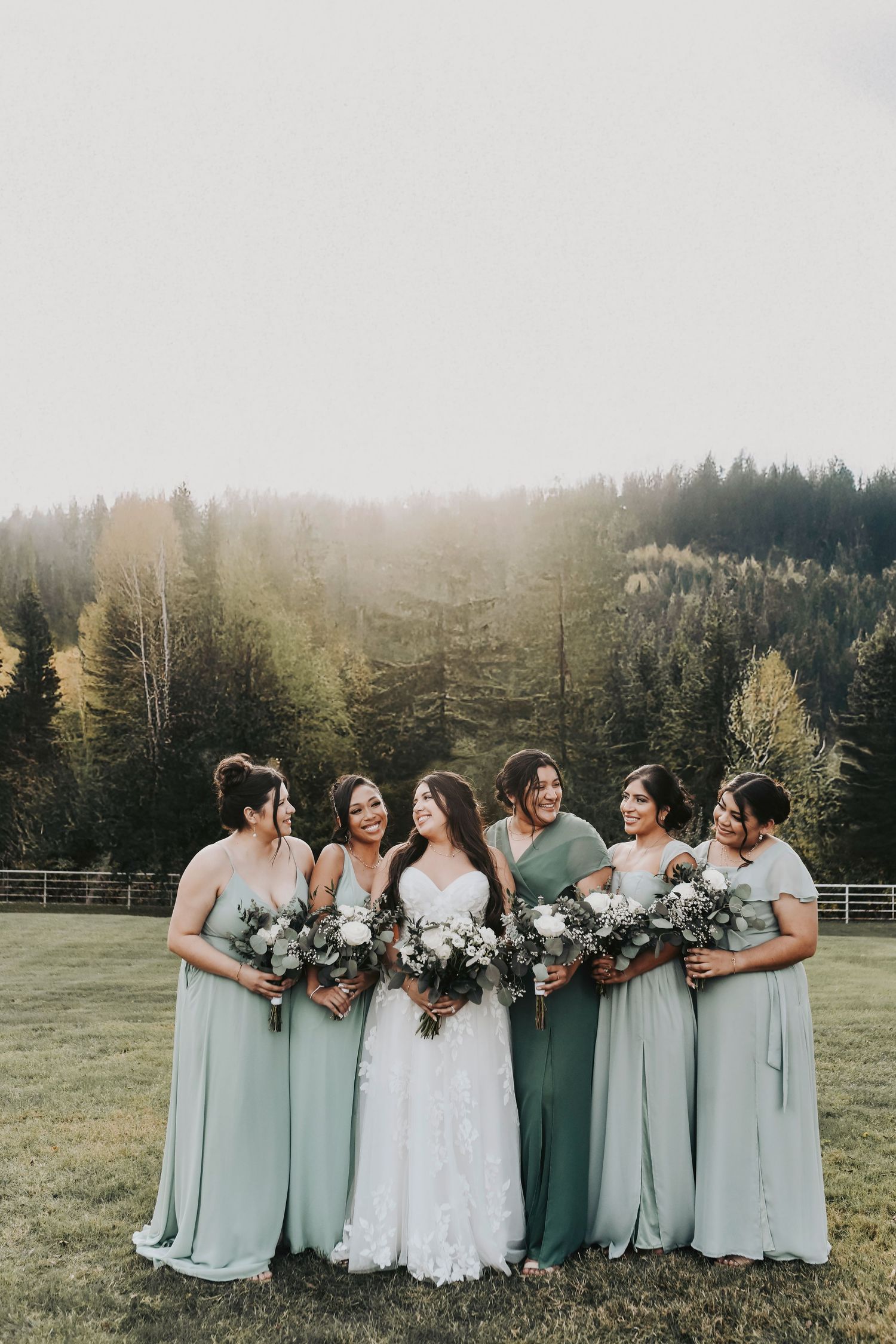 a bride and her bridesmaids pose for formal photos at firefly gardens
