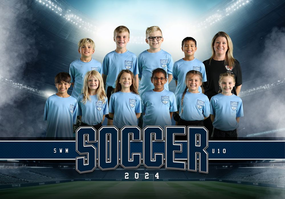 Youth soccer team in light blue jerseys posed together with dramatic stadium lighting.