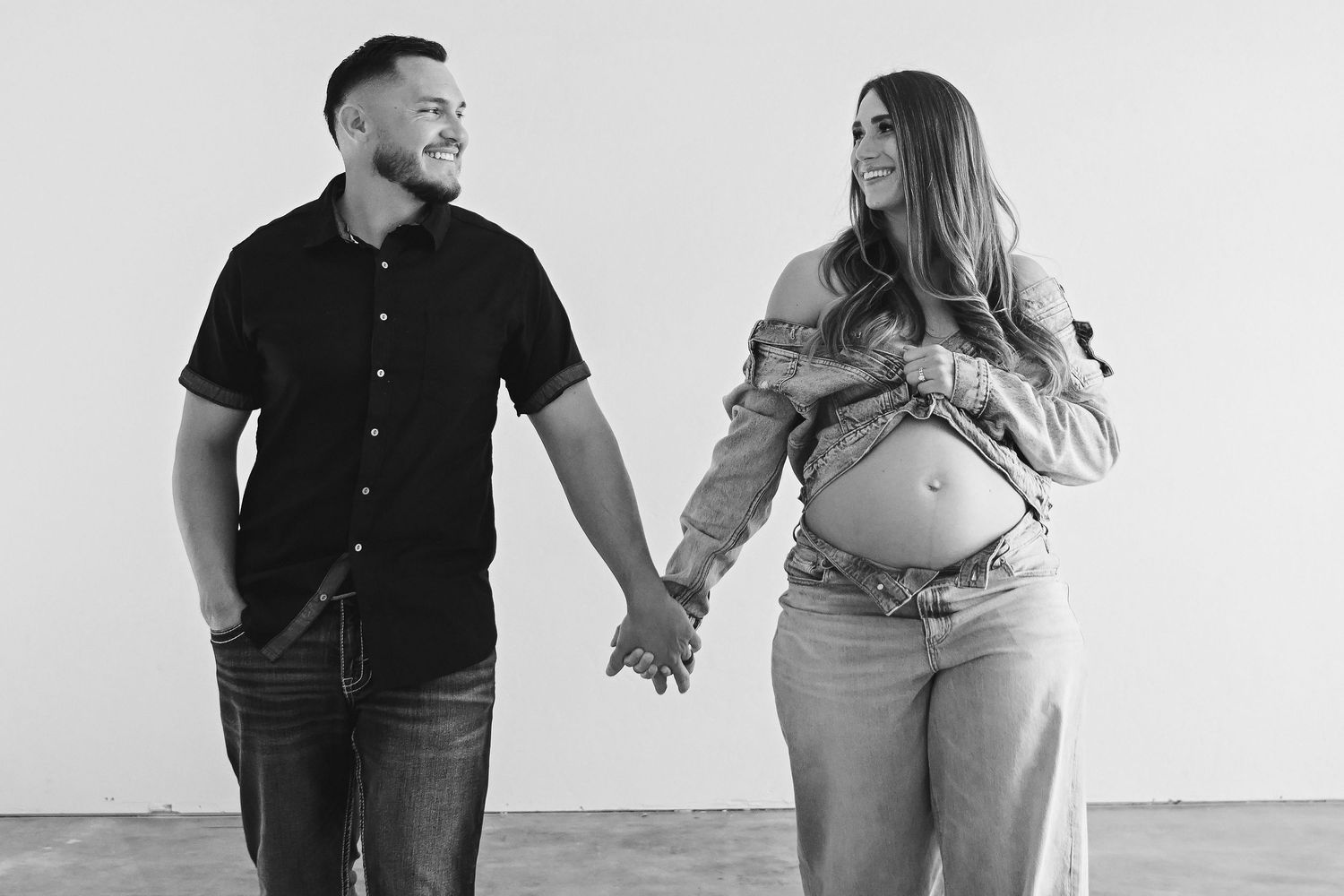 Black and white series of maternity photos showing intimate poses against a white background.