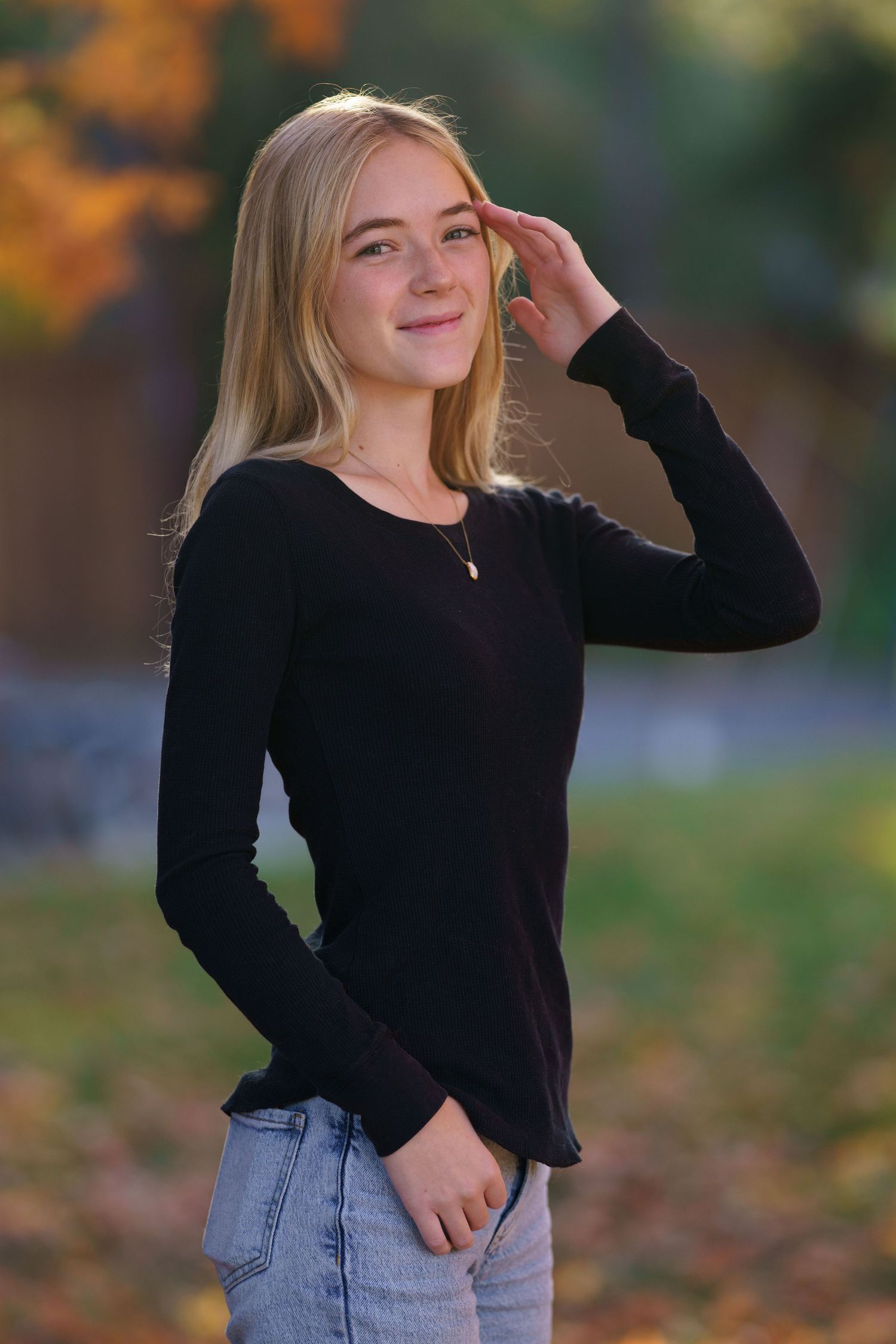 High school senior standing in a field during golden hour, by Jamie Macey Photography in Columbus, Ohio.