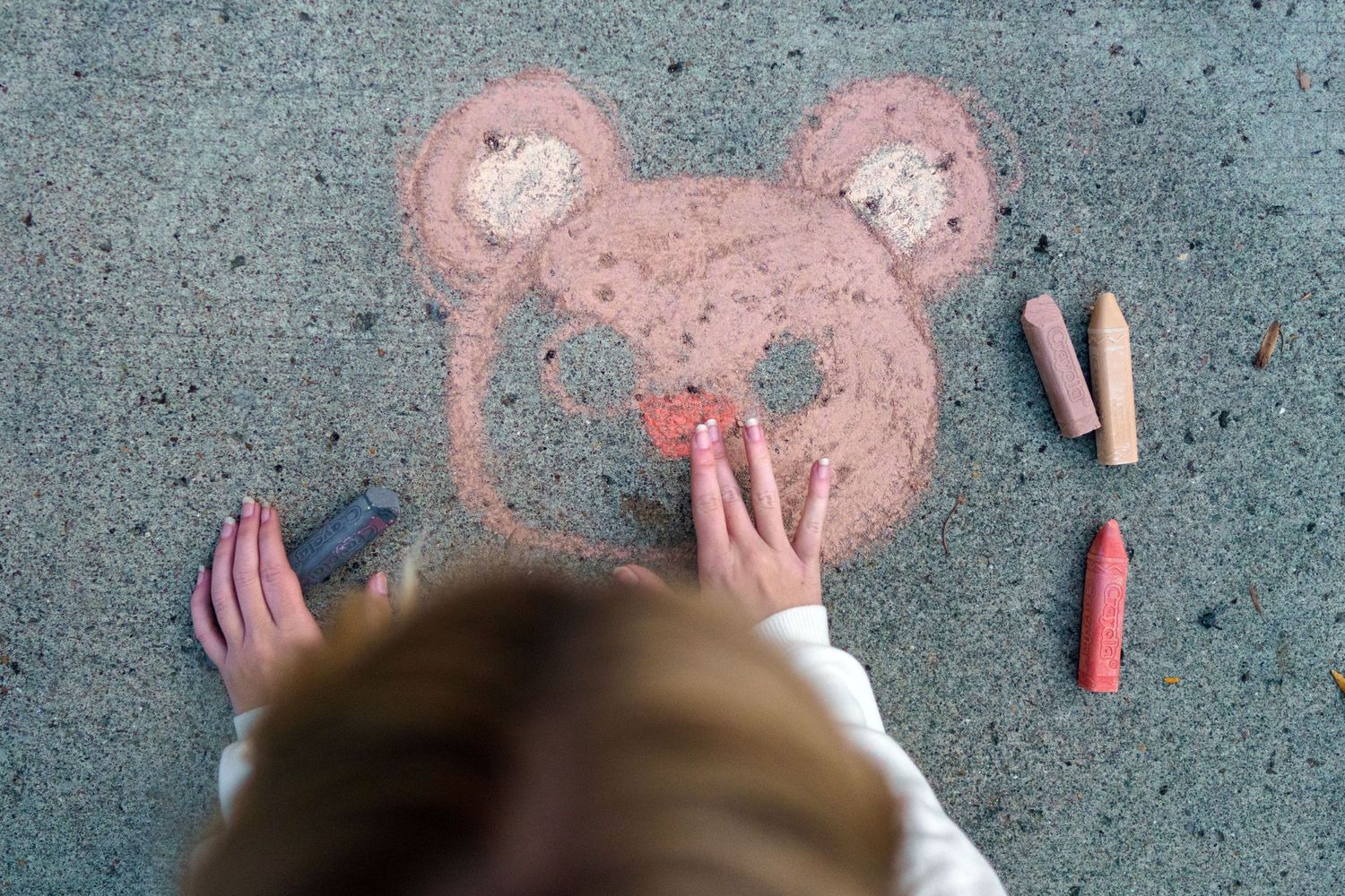 High school senior lying on the pavement beside a chalk bear drawing, by Jamie Macey Photography in Columbus, Ohio.