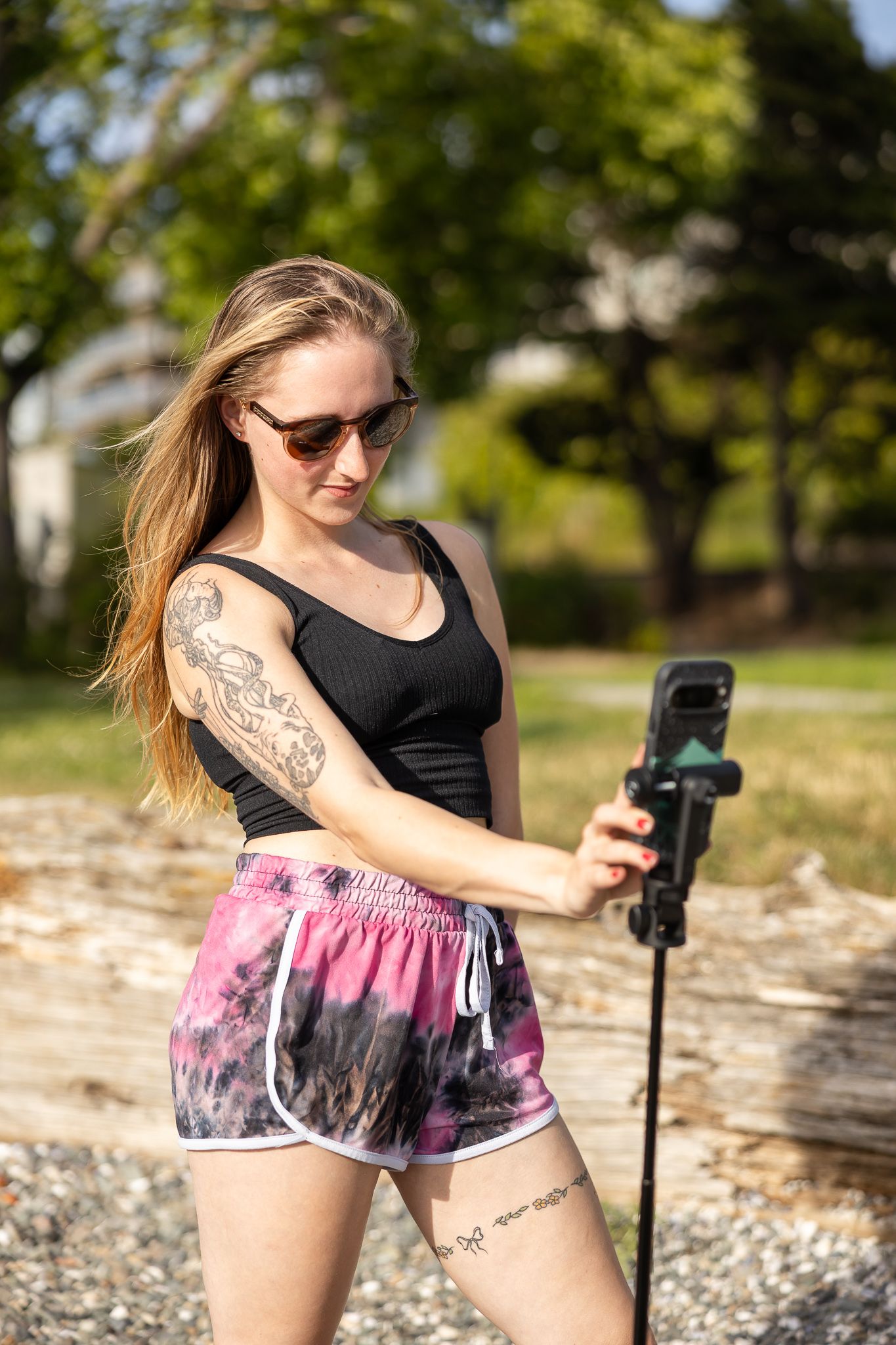 Behind the scenes of brand photoshoot in Seattle, WA of woman standing with phone on tripod filming content