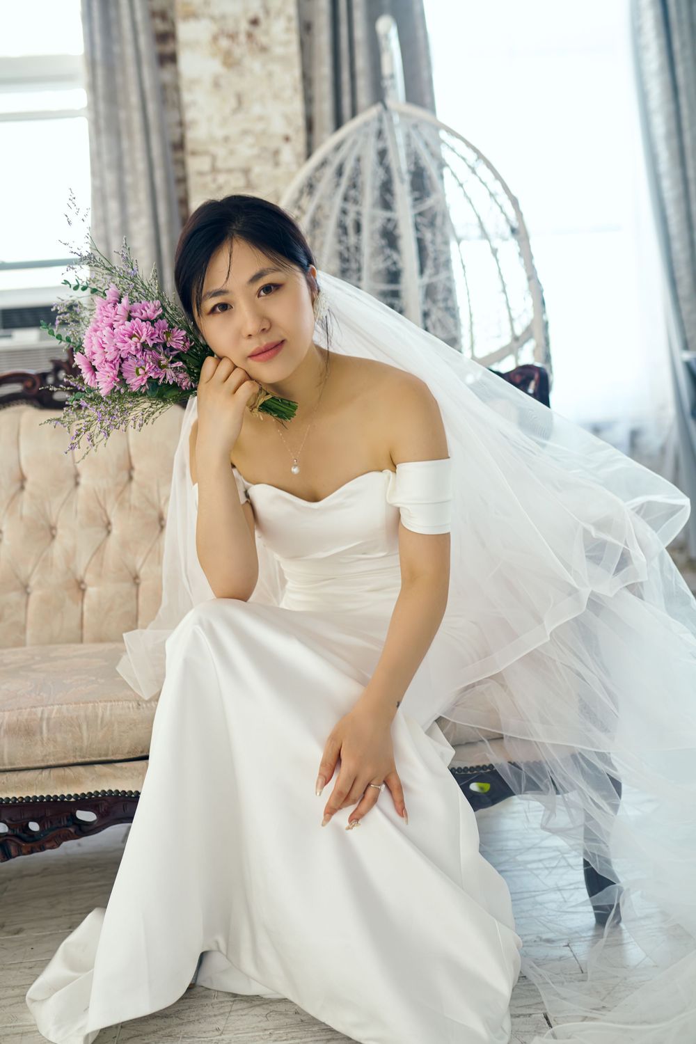 Four artistic bridal portraits in a white wedding dress with flowing tulle veil against an elegant vintage backdrop. studio photo session