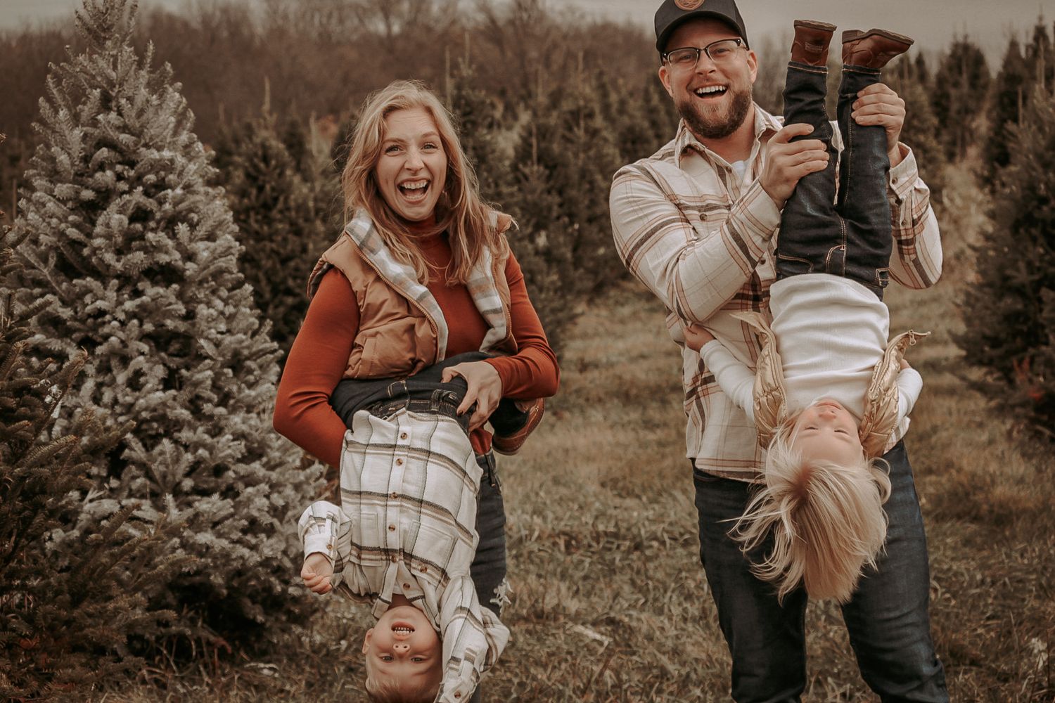 A fall family portrait session at a Christmas tree farm with warm autumn tones and cozy sweaters.