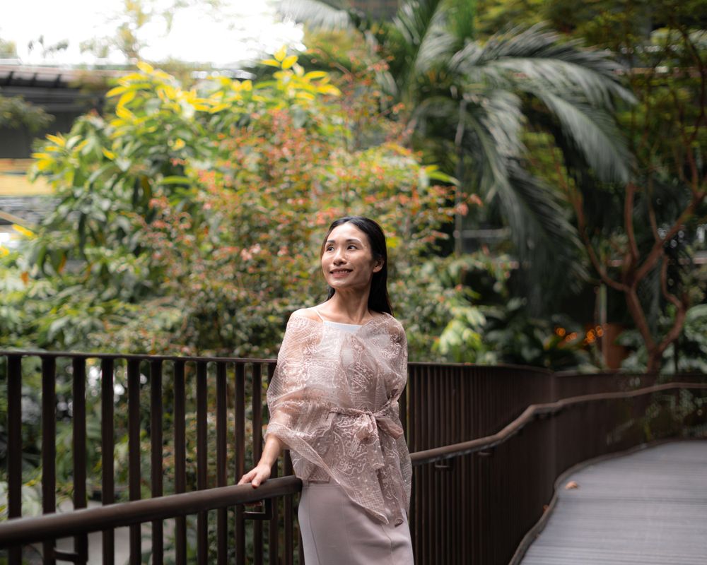 Candid moment on walkway surrounded by tropical plants and natural landscaping.