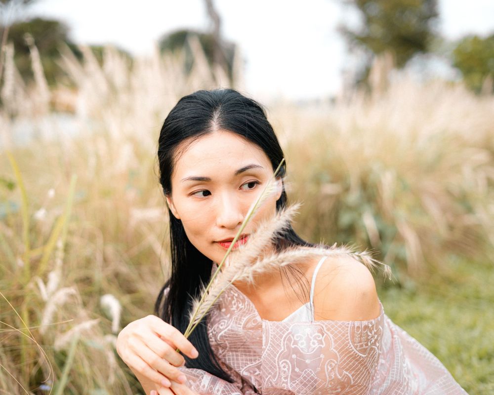 Portrait in pink dress surrounded by golden pampas grass.