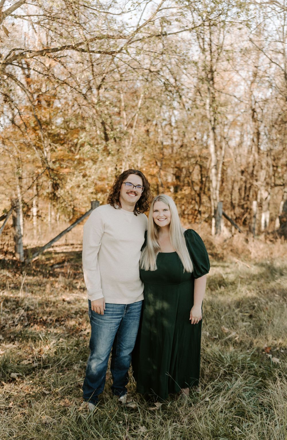 Family portrait session in autumn woods with casual outfits and natural lighting.