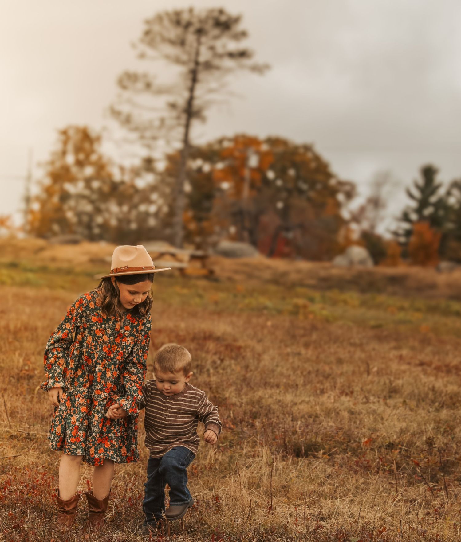 Brother and sister walking side by side exploring in Maine
