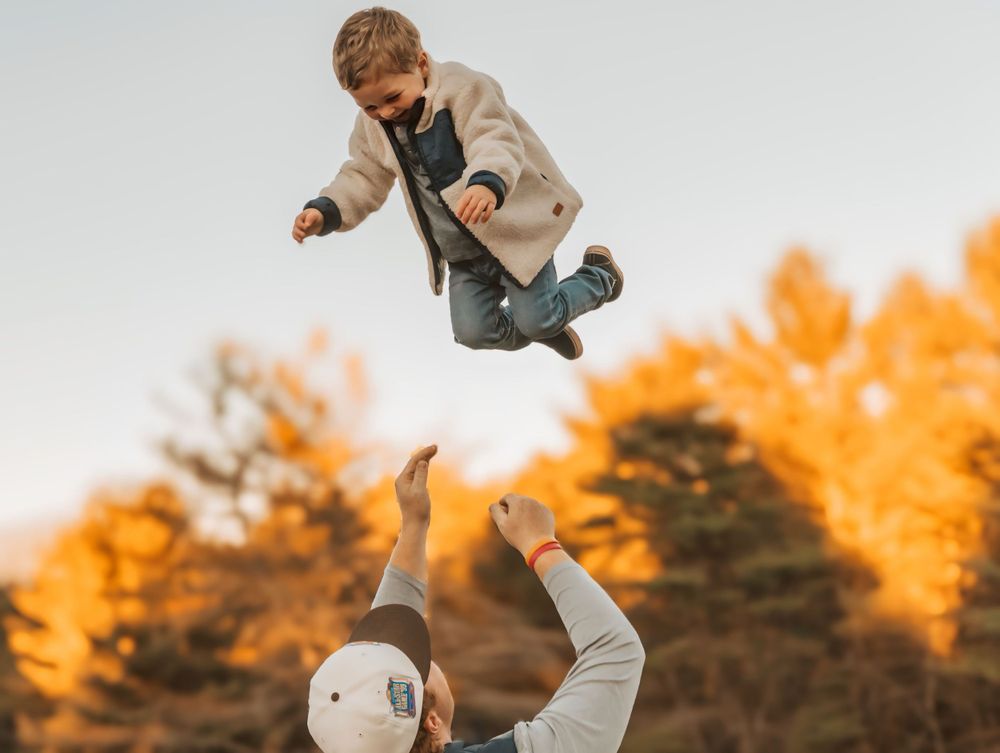 Toddler being thrown in the air in Maine