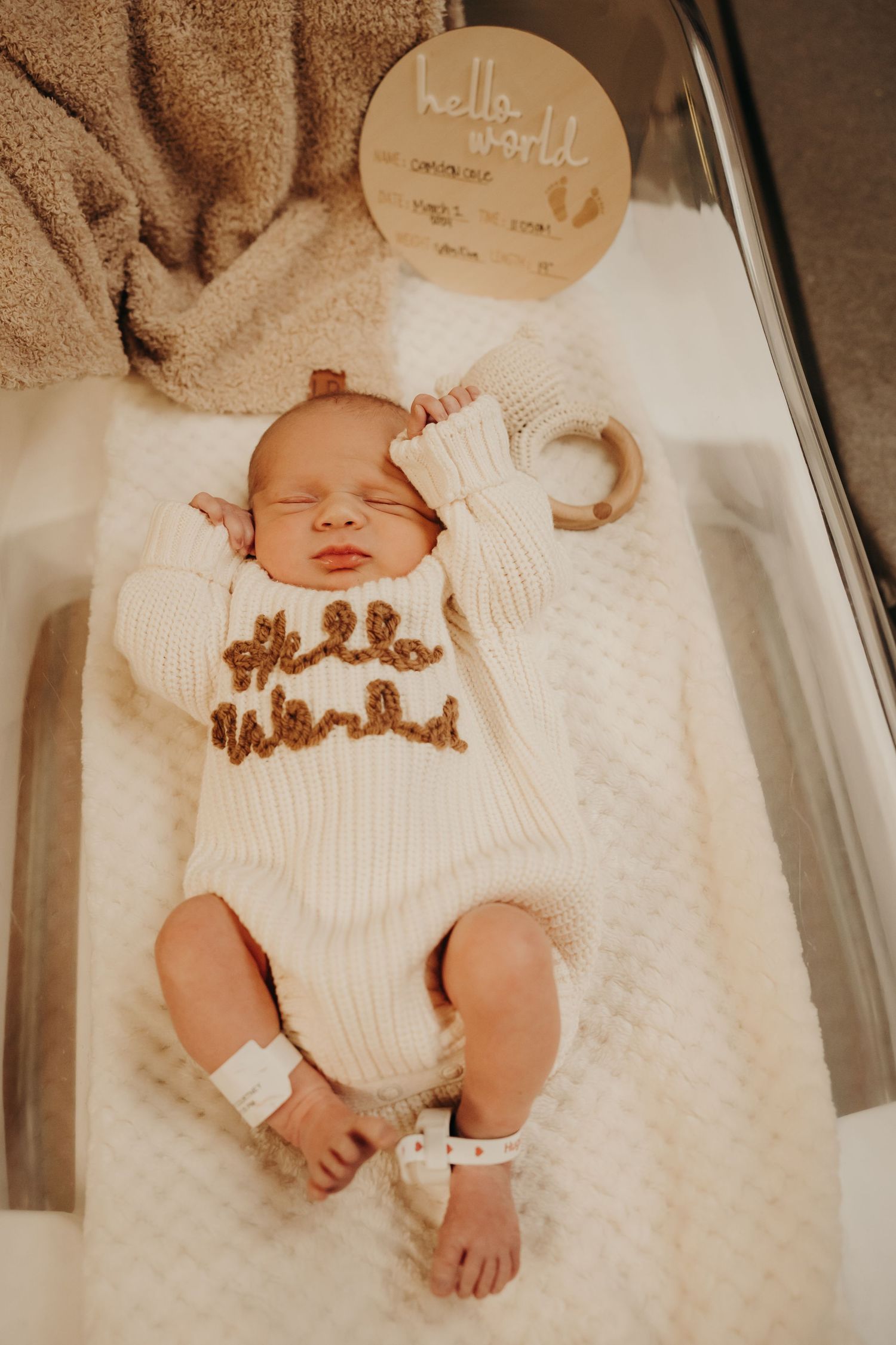 Newborn baby sleeping peacefully on a soft blanket, captured in a cozy indoor photoshoot