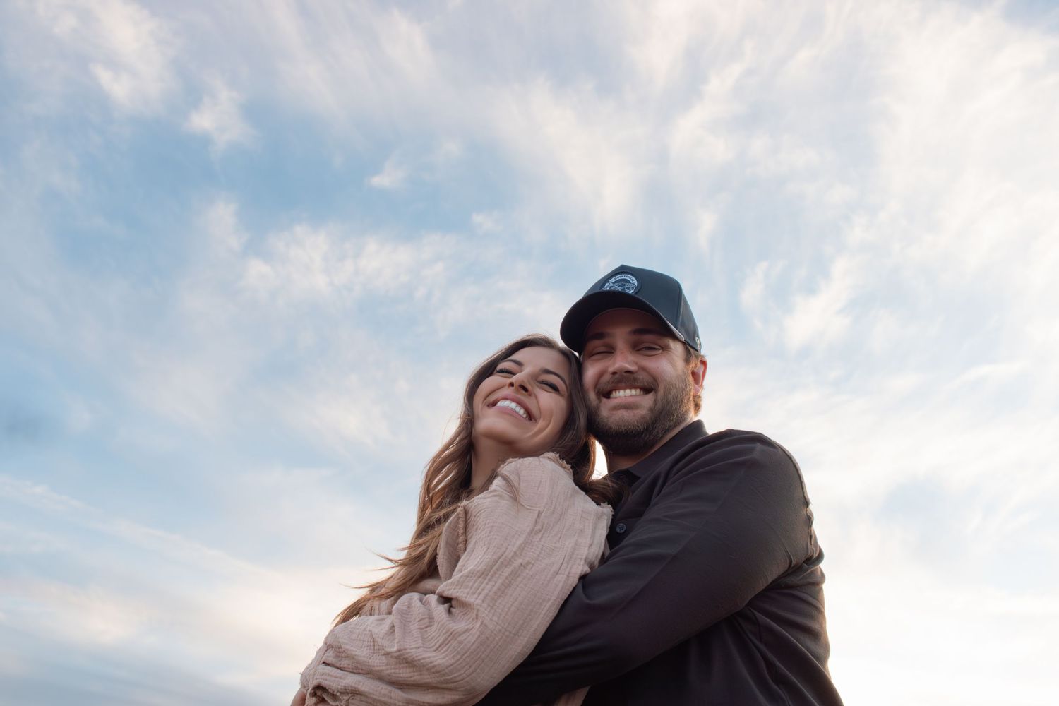 Couple photo session at sunset in the Greater Phoenix area, capturing a romantic moment with warm, glowing desert light.