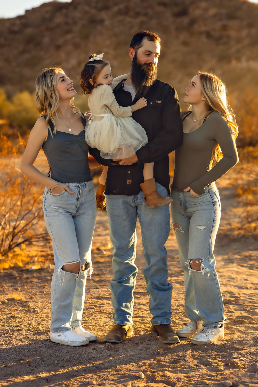 Family portraits in casual denim standing together in warm desert lighting. Father daughter photo shoot.
