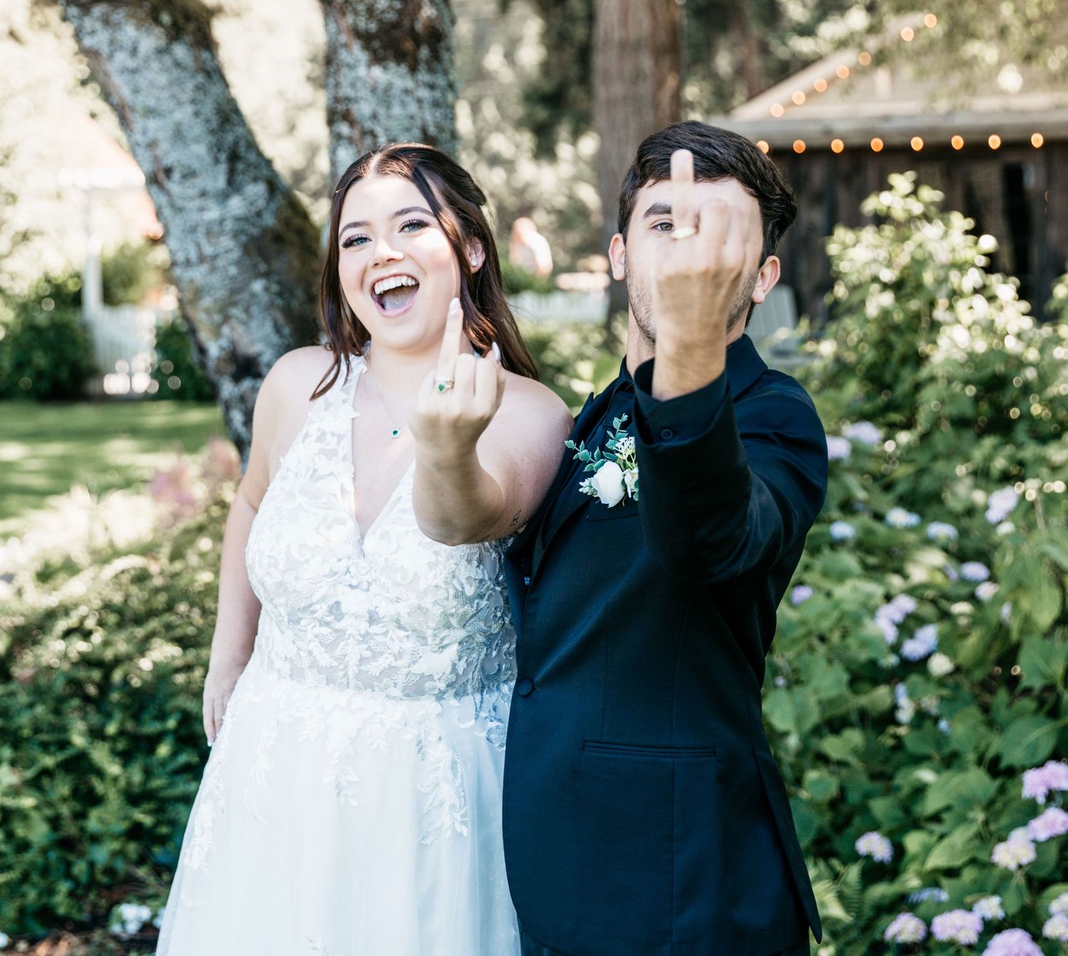 A celebratory moment captured during an outdoor garden wedding with natural lighting.