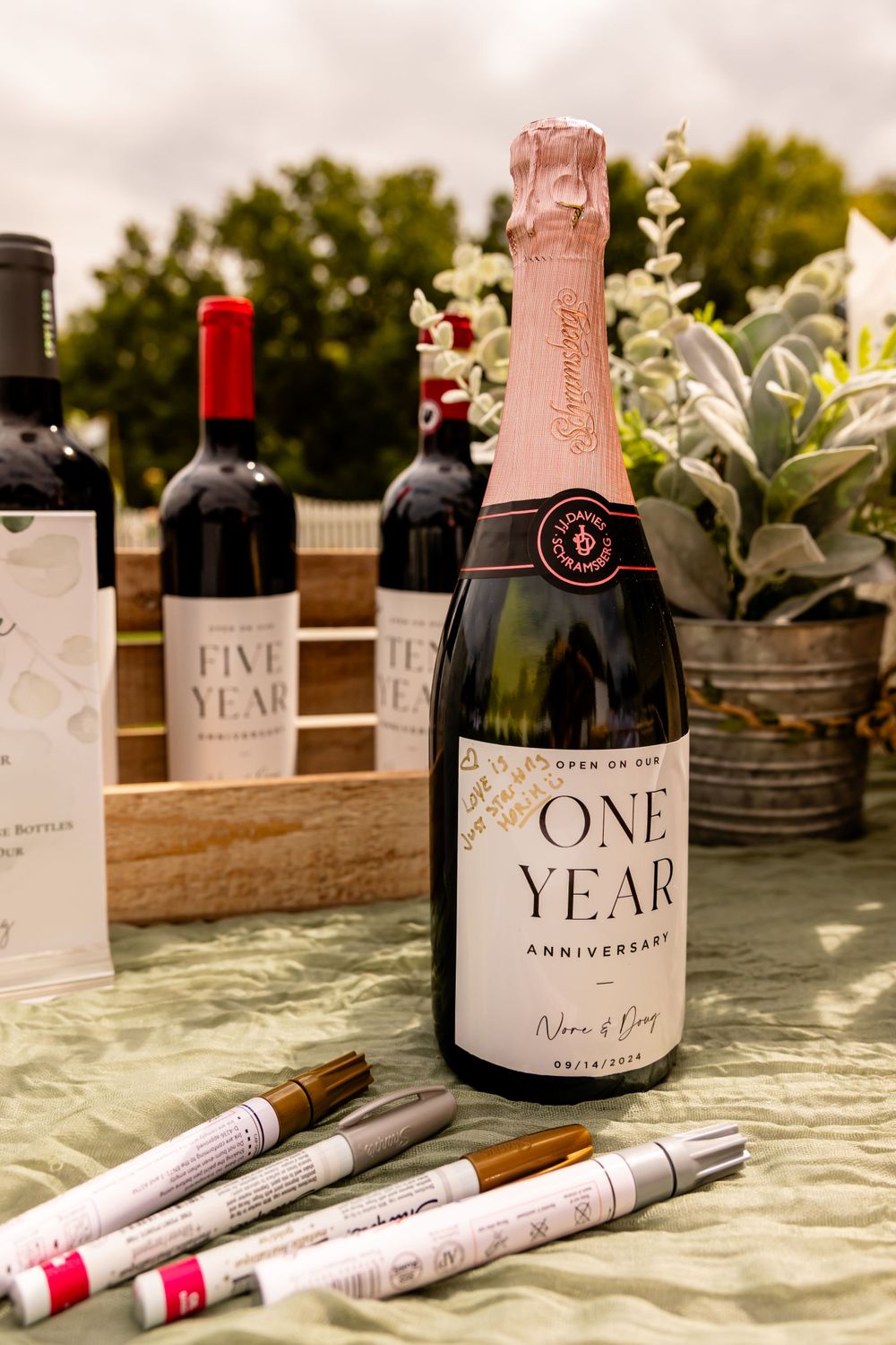 Wedding wine bottles at backyard wedding in Omaha, Nebraska. - BrightSide Photography