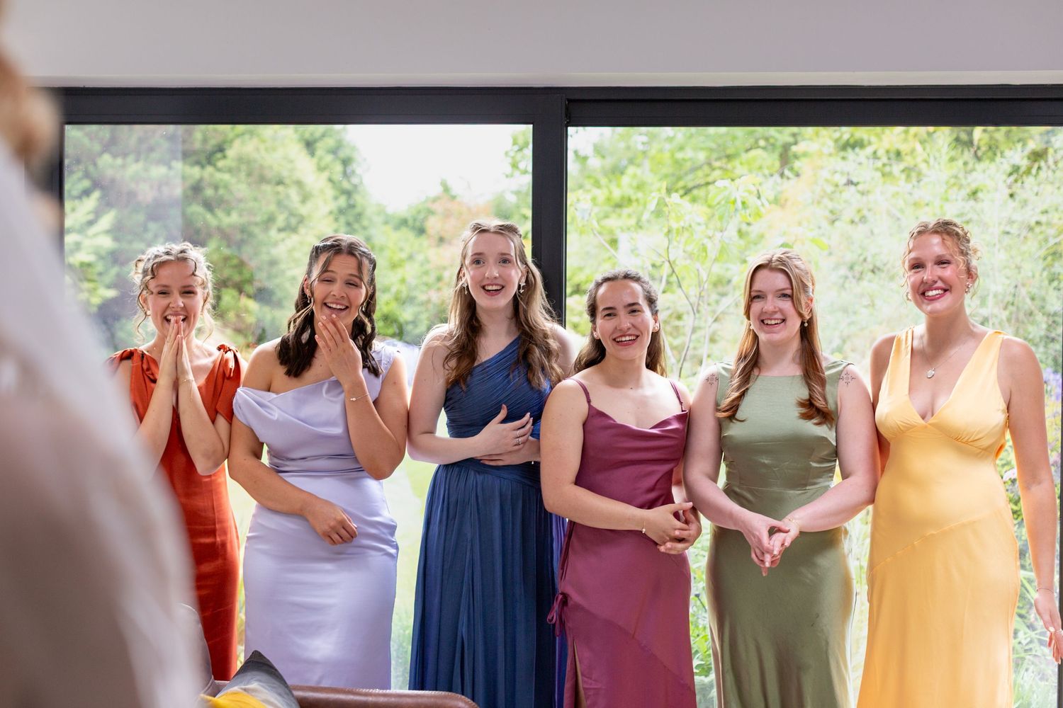 A group of people wearing colorful dresses are gathered together at an outdoor event.