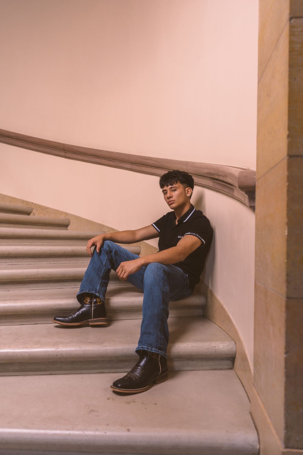 Casual portrait series on concrete steps with moody lighting.