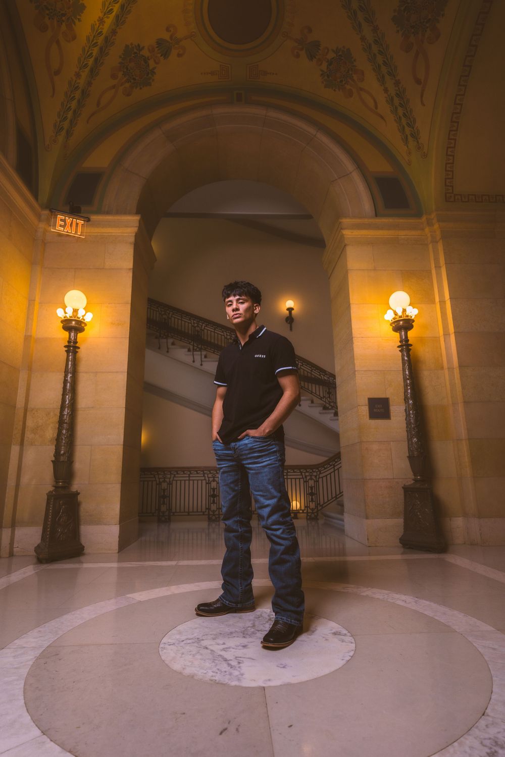 Architectural photography session in ornate building with marble floors and arched ceilings.