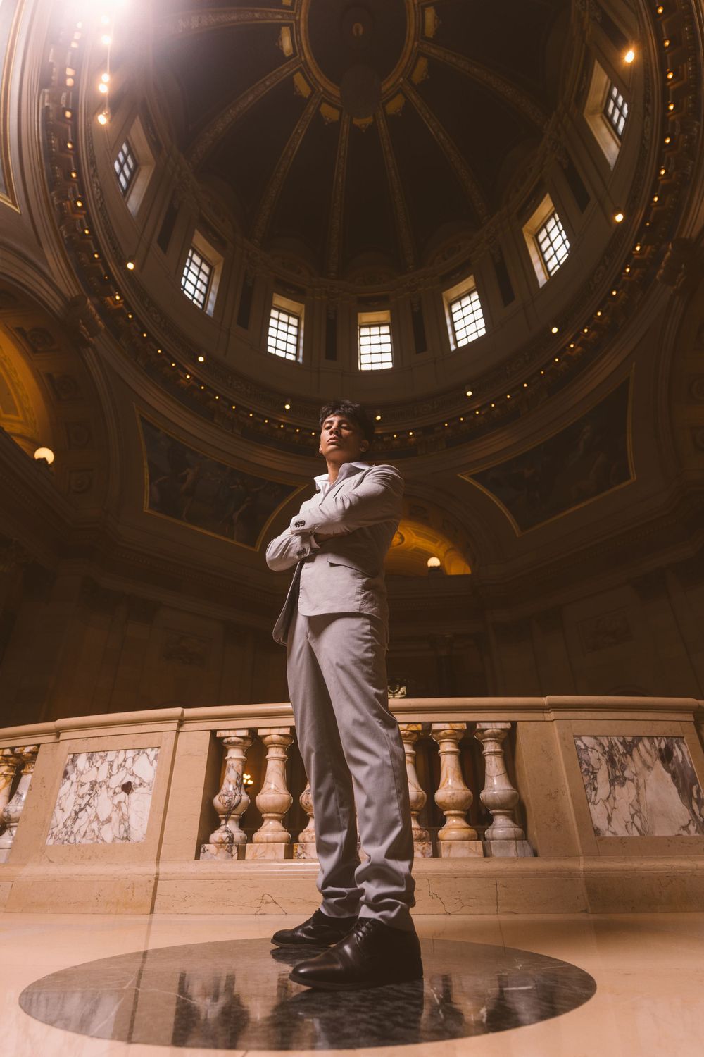 Dramatic architectural photography in domed building with ornate ceiling and columns.
