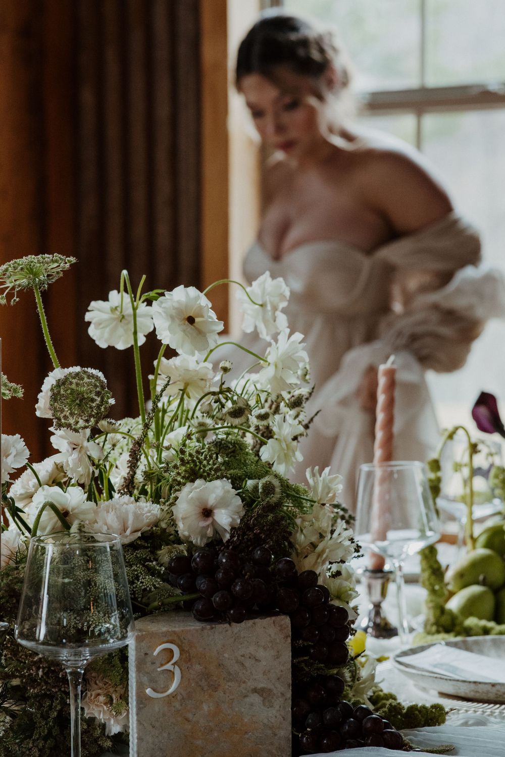 Wedding table centerpiece featuring white flowers and rustic wooden box details.