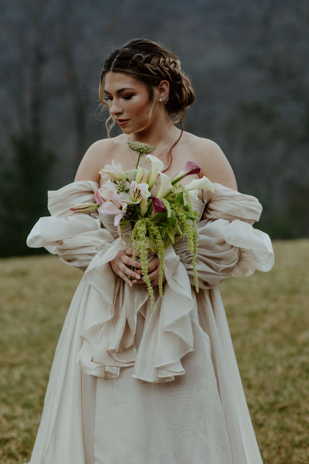 A romantic bridal portrait with a pastel and green floral bouquet.