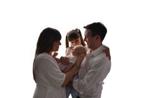 Family portrait silhouette against white background showing tender intimate moment.
