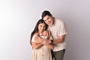 A maternity photoshoot featuring soft peach tones and natural poses.