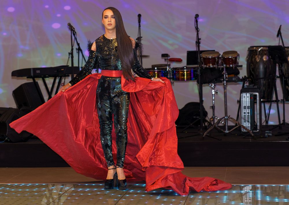 Model strutting runway in elegant gown at fashion show, dynamic event photography by SRX Media Group